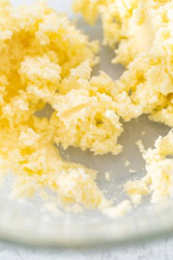 4 Temmuz pastasını çikolatalı yıldızlarla karıştırmak için cam bir kasenin içindekileri karıştırıyorum..