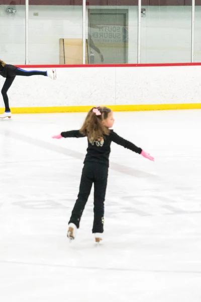 小女孩在室内溜冰场练习花样滑冰 — 图库照片