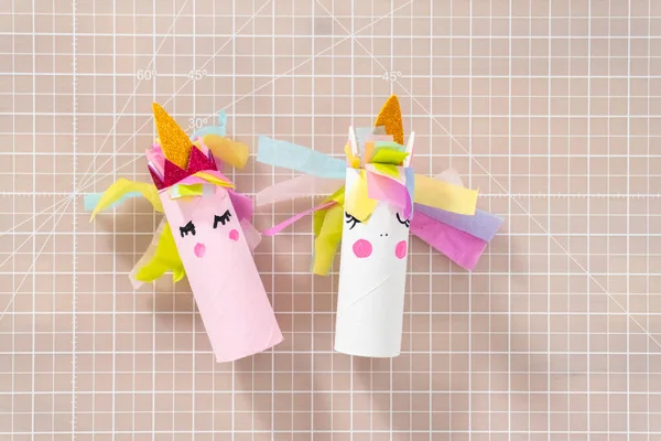 Flat lay. Making a unicorn out of the toilet paper roll and craft paper.