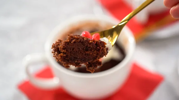 Step by step. Chocolate mug cakes garnished with whipped cream and chocolate hearts and lips.