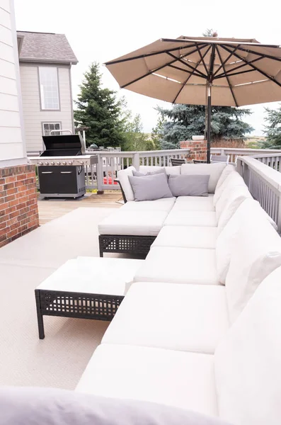 Patio of a luxury single-family home furnished with modern furniture.