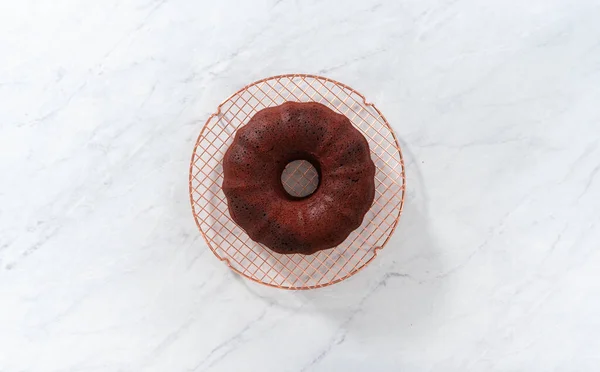 Flat lay. Cooling freshly baked red velvet bundt cake on a kitchen counter.