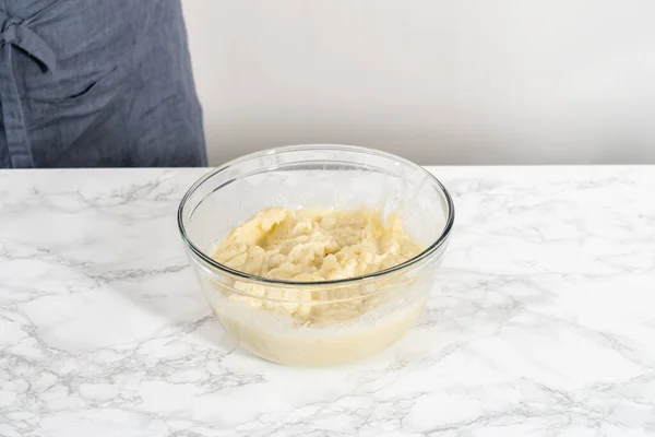 Mashed potatoes. Mashing cooked potatoes in a glass mixing bowl with a hand mixer made creamy mashed potatoes.