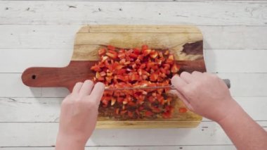 Ağaç kesme tahtasında organik kırmızı dolma biber kesiyorum..