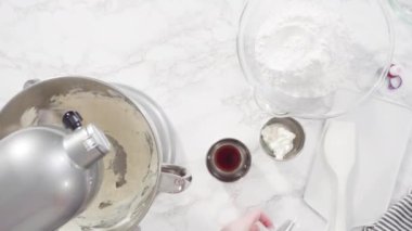 Making Red velvet cupcakes with cream cheese frosting and decorates with heart and kiss shaped red chocolates