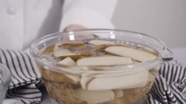 Fırında pişirmek için zeytinyağı ve baharatlı patatesler hazırlıyorum..