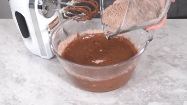 Making cake batter to bake a red velvet bundt cake.