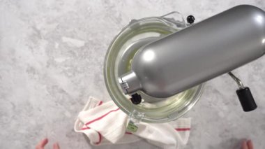 Making cake batter to bake a red velvet bundt cake.