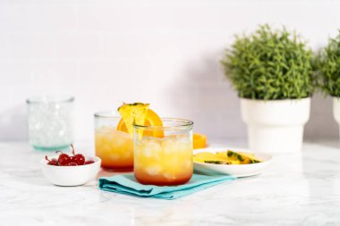 Adım adım. Bir dilim taze portakal ve ananasla süslenmiş dekore edilmemiş kokteyl..