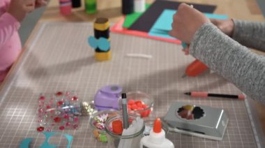 Close up view. Kids papercraft. Making paper bugs out of the empty toilet paper rolls and construction paper.