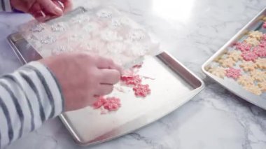 Time lapse. Step by step. Pouring melted chocolate into a plastic chocolate mold in the shape of snowflakes.