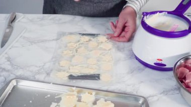 Adım adım. Erimiş çikolatayı kar taneleri şeklinde plastik bir çikolata kalıbına döküyorum..