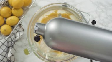 Time lapse. Step by step. Flat lay. Mixing ingredients into the batter for lemon pound cake.