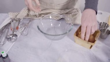 Time lapse. Step by step. Mixing ingredient in a mixing bowl with an electric mixer to bake vanilla Mardi Gras cupcakes.
