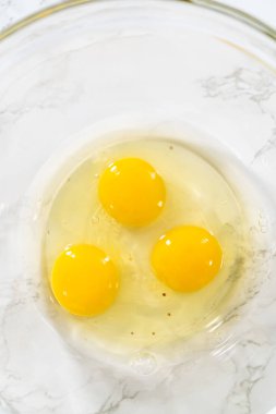 Measured ingredients in glass mixing bowls to bake American flag mini cupcakes.