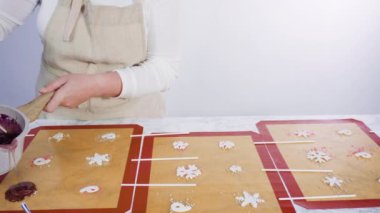 Adım adım. Ev yapımı lolipop yapmak için silikon bir fırın paspasına karamelize şeker dökmek..