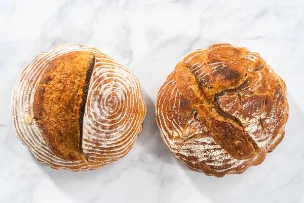 Flat lay. Freshly baked loaf of a wheat sourdough bread with marks from bread proofing basket.