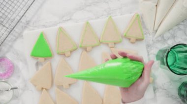 Düz yatıyordu. - Adım adım. Buzlu Noel ağacı şekilli şeker kurabiyeleri ve yeşil kraliyet kreması..