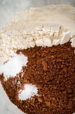 Çikolatalı kurabiyeleri naneli cipsle karıştırmak için büyük bir bardaktaki malzemeleri karıştırıyorum..