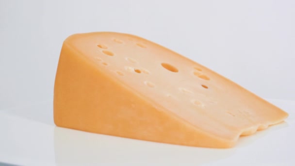 Große Scheibe Halbweicher Magerkäse Auf Weißem Hintergrund — Stockvideo