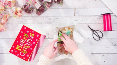 Düz yatıyordu. Adım adım. Ev yapımı şekerleme ve kurabiyeleri Noel hediyesi kutusuna koymak.