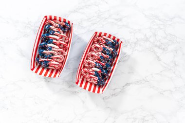 Flat lay. American flag. Red, white, and blue chocolate-covered pretzel twists.