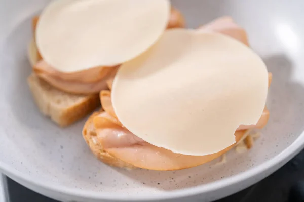 Prepare provolone and apple grilled cheese sandwich on a nonstick frying pan.