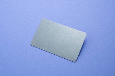Empty business card on violet background. Mock up