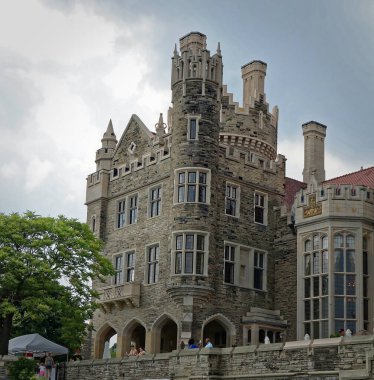 Toronto, Canada - 06 20 2016: Casa Loma building before a dark cloudy sky. Casa Loma is a Gothic Revival castle-like building that has become one of the most famous landmarks of Toronto, major