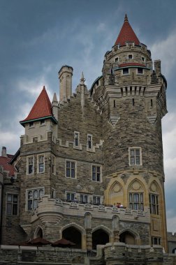 Toronto, Canada - 06 20 2016: Casa Loma building before a dark cloudy sky. Casa Loma is a Gothic Revival castle-like building that has become one of the most famous landmarks of Toronto, major