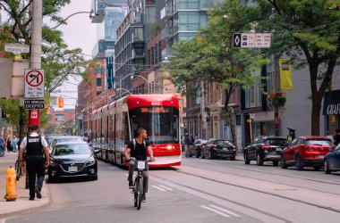 Toronto, Canada - 08 03 2018: More and more Torontonians choose healthy means of transportation like bicycles sharing Toronto streets with cars, buses, and streetcars.