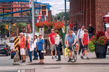 Toronto, Canada - 08 03 2018: People waiting for traffic lights on Front Street beside St. Lawrence Market South building in Old Town neighnorhood of Toronto city.