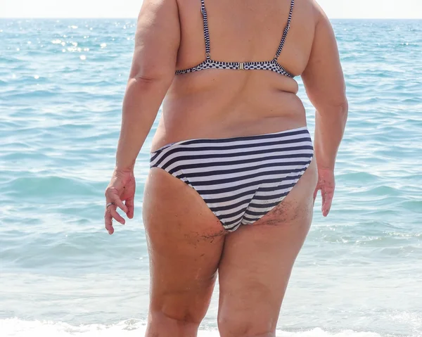 Back view of woman goes swimming Stock Photo