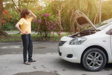 Genç stresli bir kadın yolda araba arızası yaşıyor ve birinin ona yardım etmesini bekliyor. Yoldaki araba kazası kavramı.