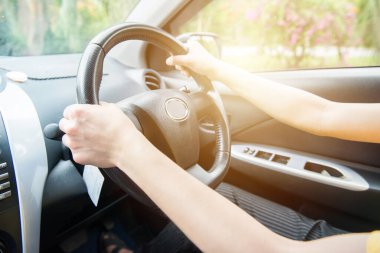 Otomobil merkezi konsolundaki ortam. Sürücü elleri kontrol arabası için direksiyonu tutuyor.