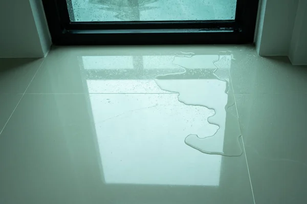 Water leaking on tile floor. Water leaks are often because of pinholes in your plumbing system or small failures in caulking or other exterior materials.