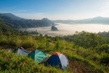 Camping point with the beautiful sunrise view of the limestone mountains and sea of fog in Phu Lung ka forest park located in Phayao the Northern province of Thailand.