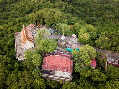 Aerial view of Wat Phra That Doi Khao Kwai located on the small mountain peak in Chiang Rai province of Thailand. This place is the best spot for see panoramic view of Chiang Rai cityscape.