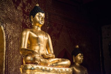 Beautiful Buddha statue in traditional Lanna style located in Wat Phra Singh, Chiang Mai province of Thailand.