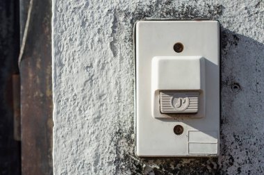 Door bell button at the front door. A doorbell is a signaling device typically placed near a door to a building's entrance.