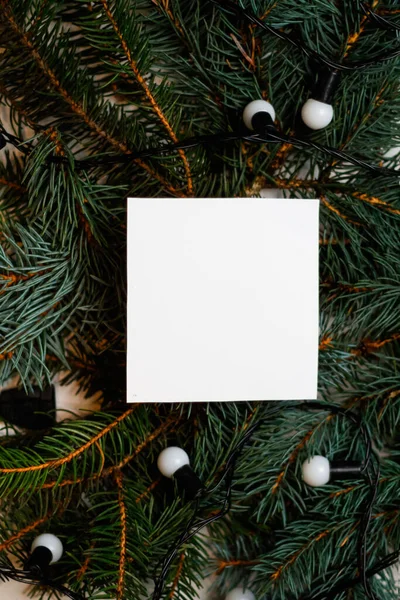Desenfocar Tarjeta Blanca Blanco Sobre Fondo Natural Navidad Con Lámparas —  Fotos de Stock