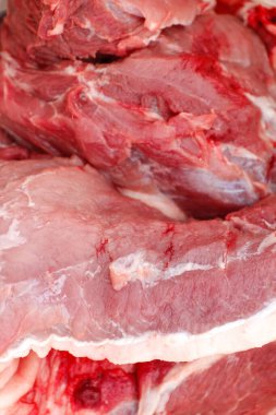 Defocus texture or background of tasty fresh meat of big, pork. Red beef meat close up texture. Meat food background. Blurred. Vertical. Out of focus.