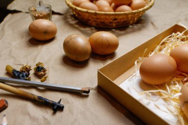 Paschal yumurtalarını süslemek için aletler, Pysankas. İş yeri. Kırsal bir geçmişi var. Yumurta koleksiyonu. Yumurta çizmek için ev yapımı kalem. Tatil için hazırlık. El işi kağıdı. Gelenek işte. Etnik. Dekorasyon. Yakın çekim.
