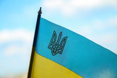 Defocus Ukraine flag. Closeup trident. National symbol fluttering in blue sky. Support and help Ukraine, Independence Constitution Day, National holiday. Peace. Patriot. Emblem country. Out of focus.