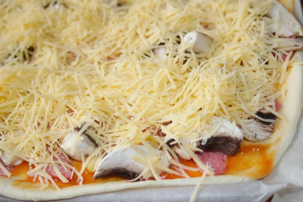 Defocus, taze rendelenmiş mozzarella peynirli tüm pizzayı yakından çek. Defocus hamur üzerinde pizza malzemelerini bulanıklaştırdı. Uzayı kopyala İtalyan mutfağı geçmişi. Arkaplan. Odaklanamıyorum.