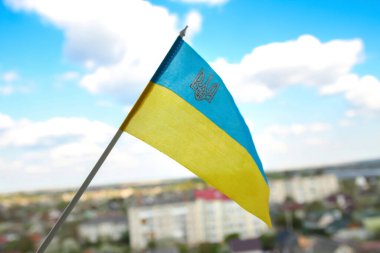 Defocus Ukraine flag. Large national symbol fluttering in blue sky. Small yellow blue Ukrainian state flag, Independence Constitution Day, National holiday. Out of focus.