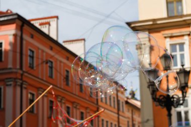 Defocus colorful bubble on city. Blowing big soap bubbles in the air. Vintage freedom, summer concepts. Blurred. Out of focus.