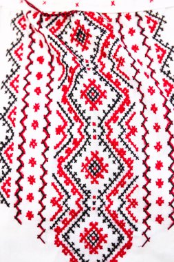 Defocus emboidery ukrainian pattern background. Ukrainian ornament. Ornaments embroidered on clothes. Ukraine embroidered on a white background. Vyshyvanka closeup. Out of focus.