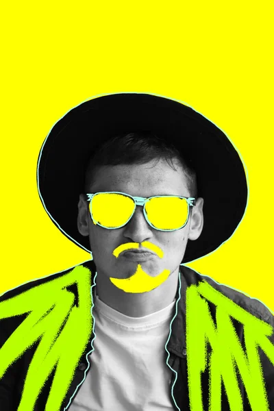 Funny art man. Smiling fashion man. Portrait of handsome smiling stylish hipster model. Man in sunglasses and hat. Fashion male on yellow background. Yellow moustache and beard. Bright shirt.