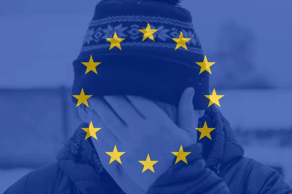 Defocus man hiding face. Flag European Union. Increase in the cost of gas bill. Soaring energy prices. Increase in the price of natural gas. Economy gas. Energy crisis in Europe. Out of focus